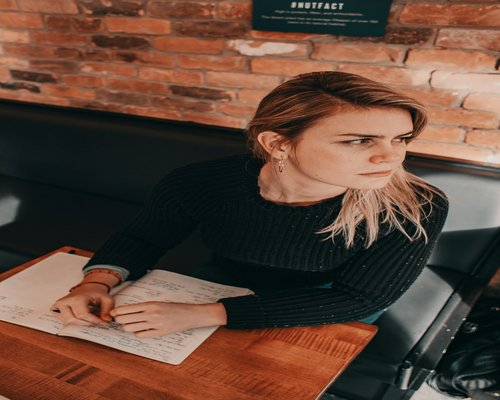 A Canadian resident studying financial literacy materials at a well-lit desk