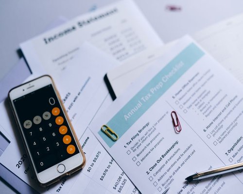 A detailed household planning checklist next to a calculator and pen