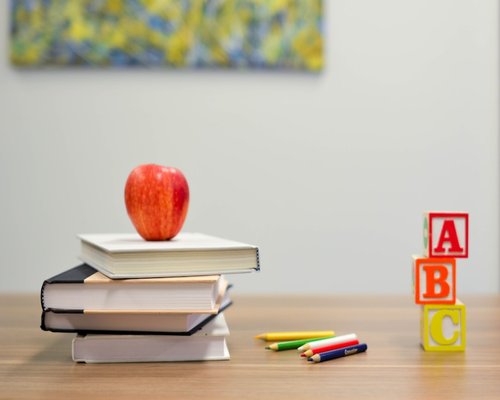 Educational resources organized neatly on a desk to show a clear learning path